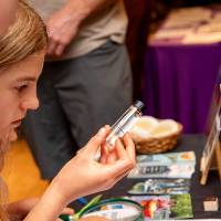 young girl examining vial at student exhibit table